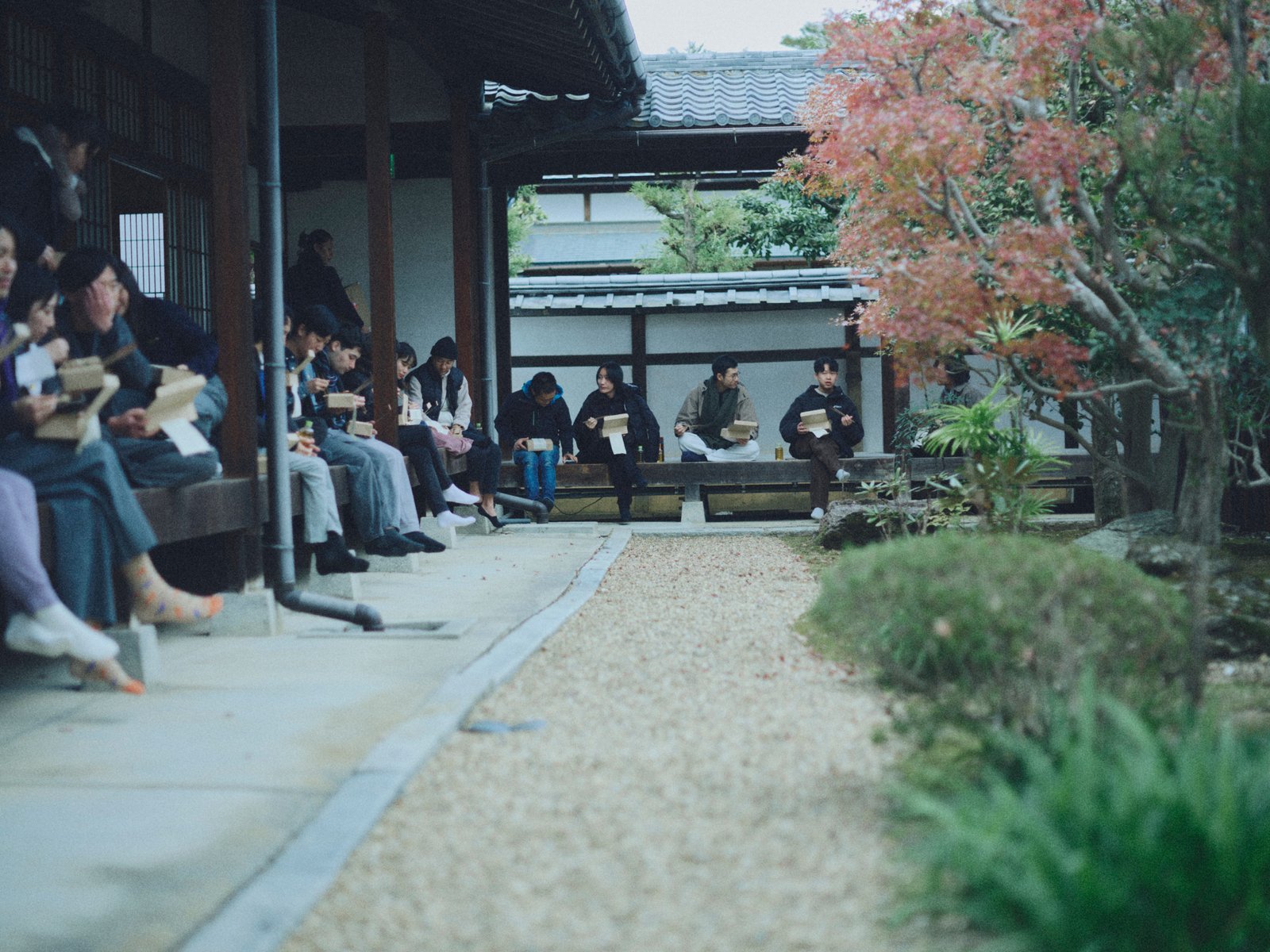 People seated along verandas around an open garden.